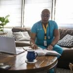 Black Female Nurse Studying Between Shifts