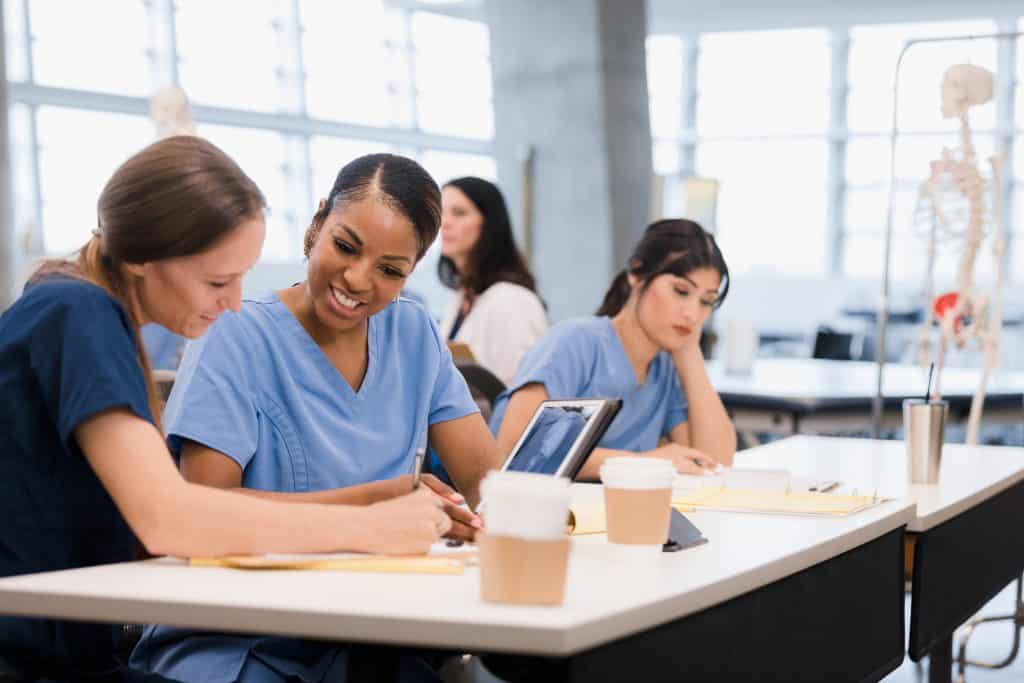 Two miramar ASN nursing school students co-operate on classwork