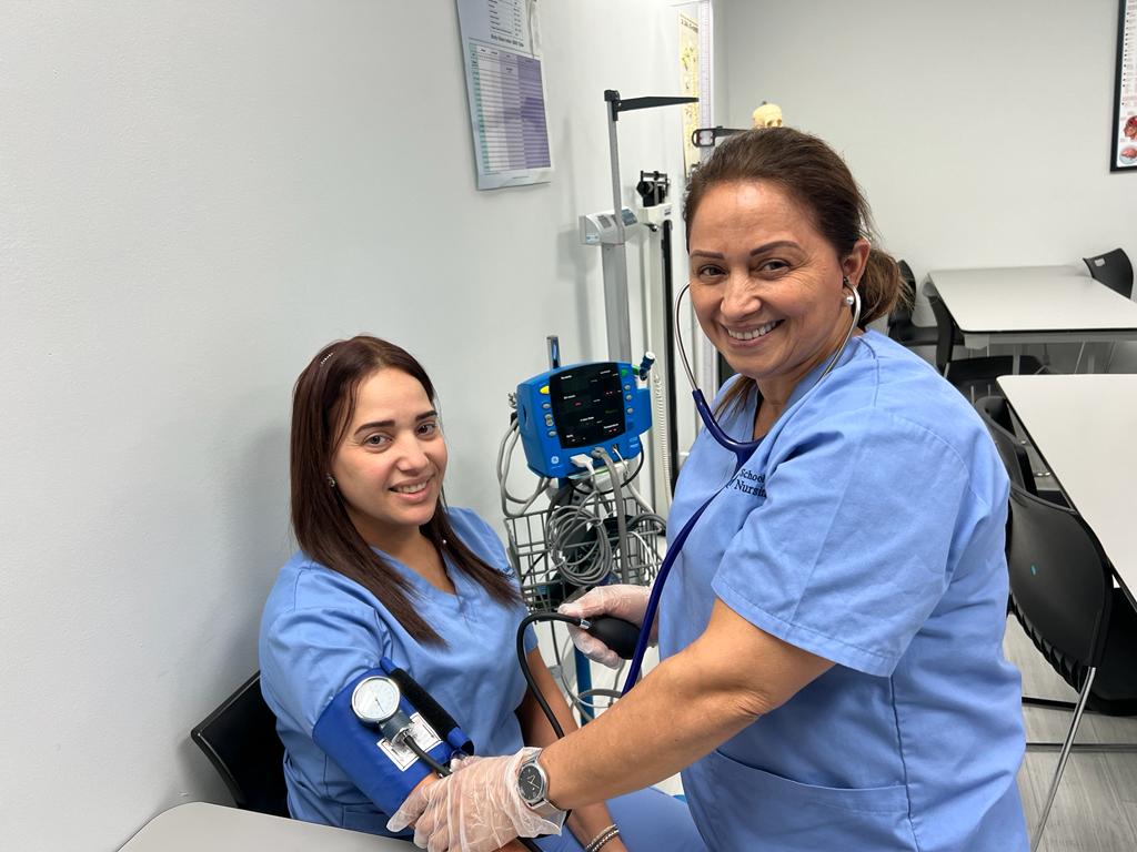 Medical assistant students take measure blood pressure